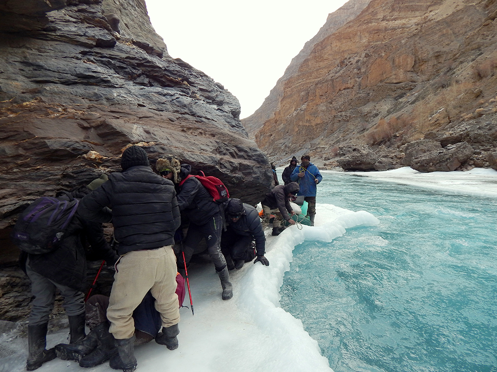 Walking cautiously on the ice formed on the edges of the river