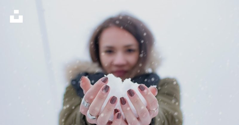 girl holding snow in her hands