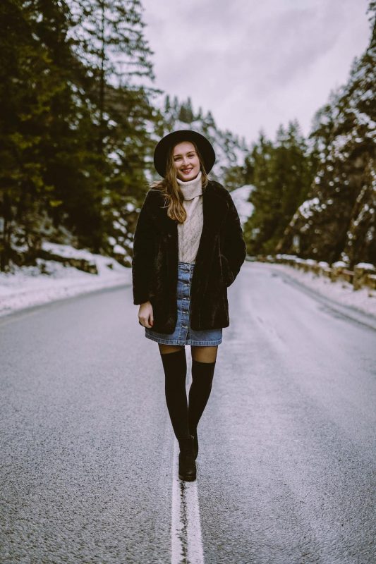 woman wearing a layered sweater outfit